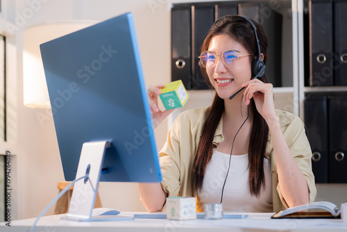 Young asian creative woman development packaging cosmetic and skincare product design with AI artificial intelligence, businesswoman using headset with marketing for conference online, call center.