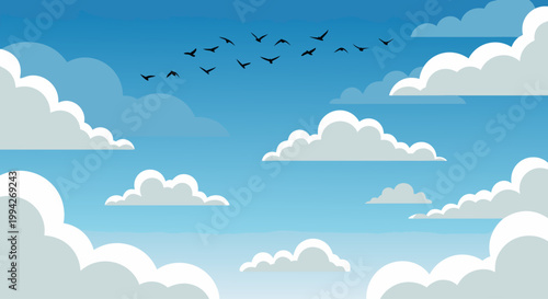Blue sky with floating clouds and flock of birds overhead