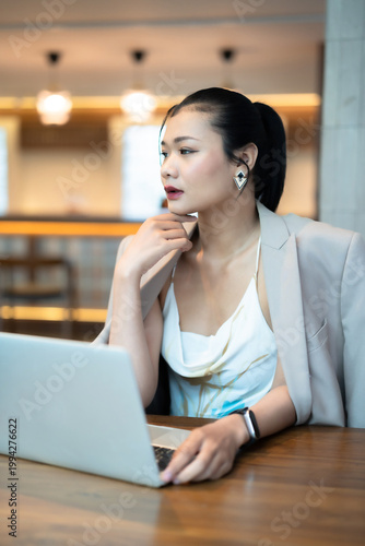 Portrait of asian freelance people businesswoman casual working with laptop computer in cafe interior in coffee shop background,business expressed confidence embolden and successful concept