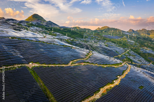 Photography Aerial view of large scale solar power plant on green mountain slopes for renewa