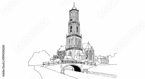 Ornate church tower rises above a medieval town with a stone arch bridge over water