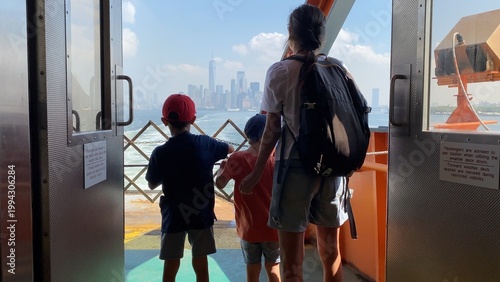 Fotografie Family enjoying a ferry ride across the bay, observing the iconic new york city