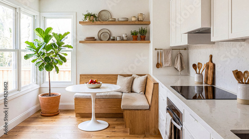 Photos Modern and bright kitchen and dining area with light wood accents, built-in banquette seating
