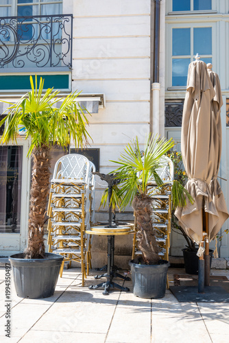 Close summer cafe in the city. Chairs and tables outside on the street.