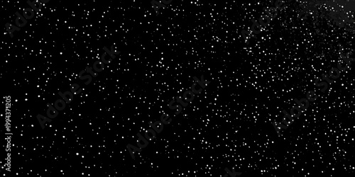 A dark background with numerous small bright white speckles scattered throughout