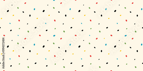 Colorful confetti scattered across a light beige background texture