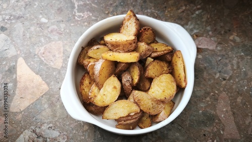 Roasted potatoes. Baked potato wedges in bowl
