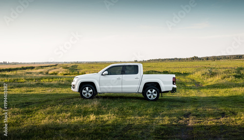 Konstfotografi White four-door pickup truck in a summer field