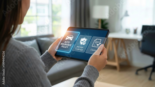 Woman using a digital tablet to manage auto insurance policy online at home office with virtual interface icons for vehicle protection coverage claims and security risk management services.