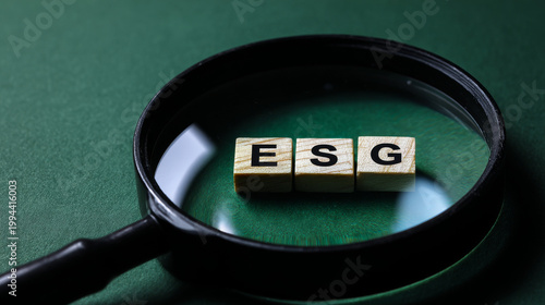 Words ESG. on magnifier glass with green backgroud. Concept of environmental, social and governance. Sustainable and ethical business. account the environment, society and corporate governance.
