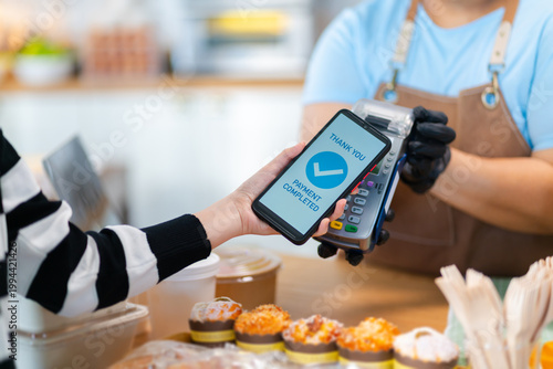 Cuadro en lienzo Customer using smartphone for contactless payment at bakery shop