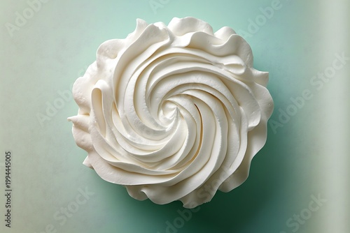Close-up of a Swirled White Meringue on a Soft Teal Background