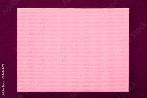 blank pink watercolor canvas laying on maroon cardboard