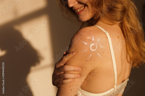 Sunscreen applied on shoulder with moles for skin protection and UV care