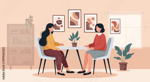 Two women are seated facing each other in a softly lit room seemingly engaged in conversation