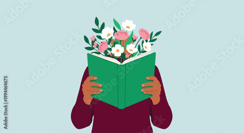 Person holding a green book with flowers on top, reading or studying in a calm and peaceful environment