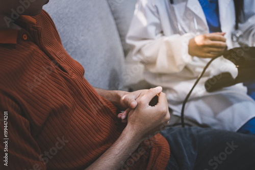 Doctor checks patient's blood pressure with cuff and stethoscope in a medical
