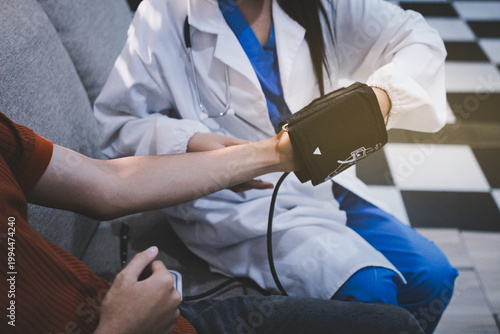Doctor checks patient's blood pressure with cuff and stethoscope in a medical