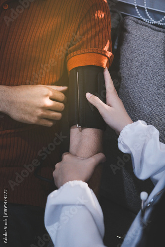Doctor checks patient's blood pressure with cuff and stethoscope in a medical