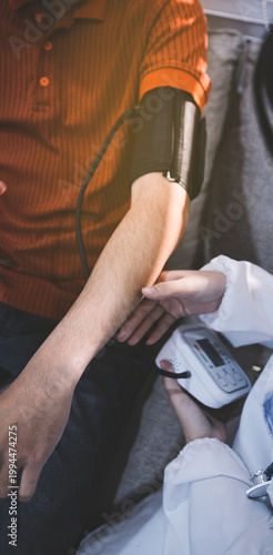 Doctor checks patient's blood pressure with cuff and stethoscope in a medical