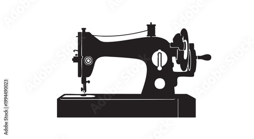 Vintage sewing machine on platform with thread spool and hand crank classic tool for tailoring.