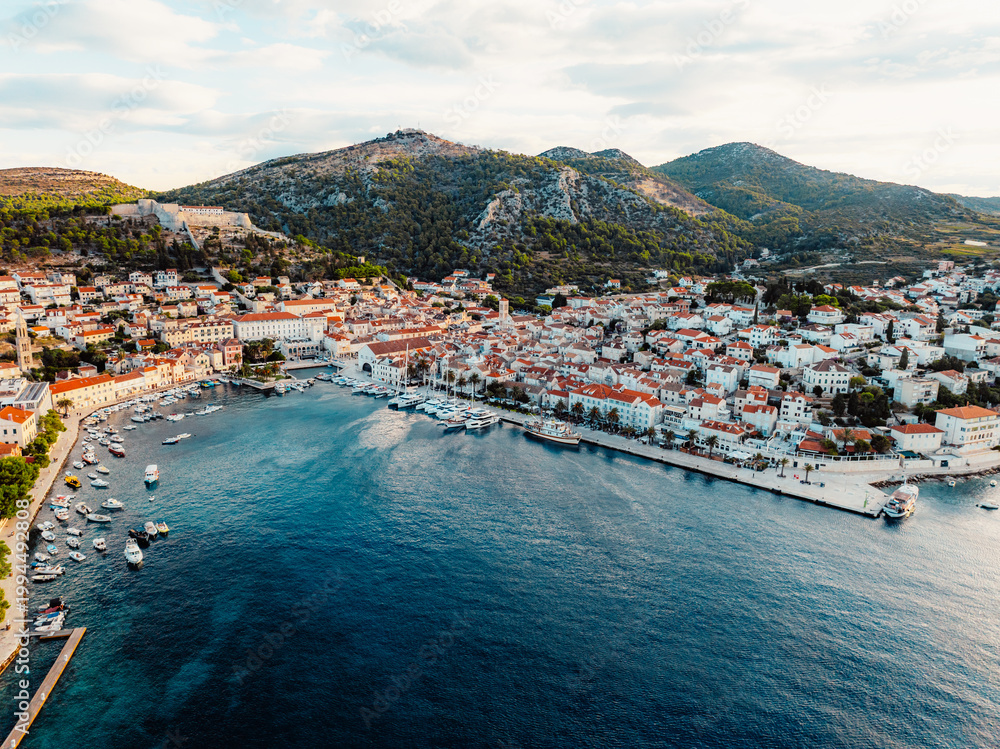 Fototapeta premium Aerial view of the historic Hvar town and the Spanish Fortress (Fortica) overlooking the harbor and Adriatic sea, Hvar island, Dalmatia, Croatia.