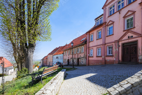 Srebrna Gora, Poland. Bright spring day in a small town with colorful buildings and trees lining the street in Poland