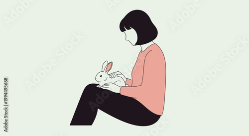 Woman sitting with white rabbit.