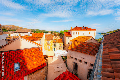 Fotografija panoramic view over the historic red roofs of Trogir old town and the Adriatic sea from the bell tower of St