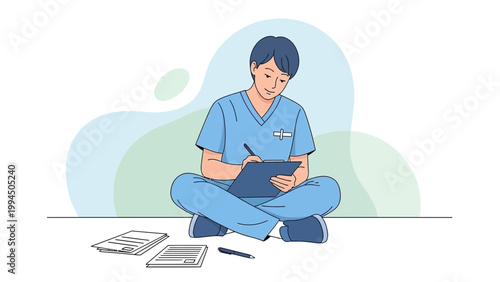 Nurse in scrubs writing on clipboard, sitting cross-legged with papers