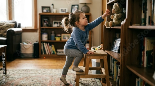 Young caucasian female child reaching for teddy bear in cozy living room