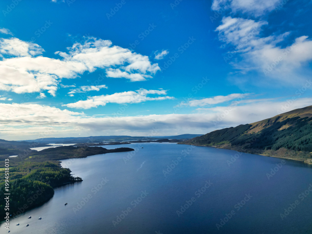 Obraz premium April 19th, 2026. Aerial View of Balmaha Valley Glasgow Landscape During Sunset Time. The village is a popular tourist destination for picnickers and day trippers from Glasgow