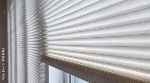 White pleated cellular blinds on window in home interior