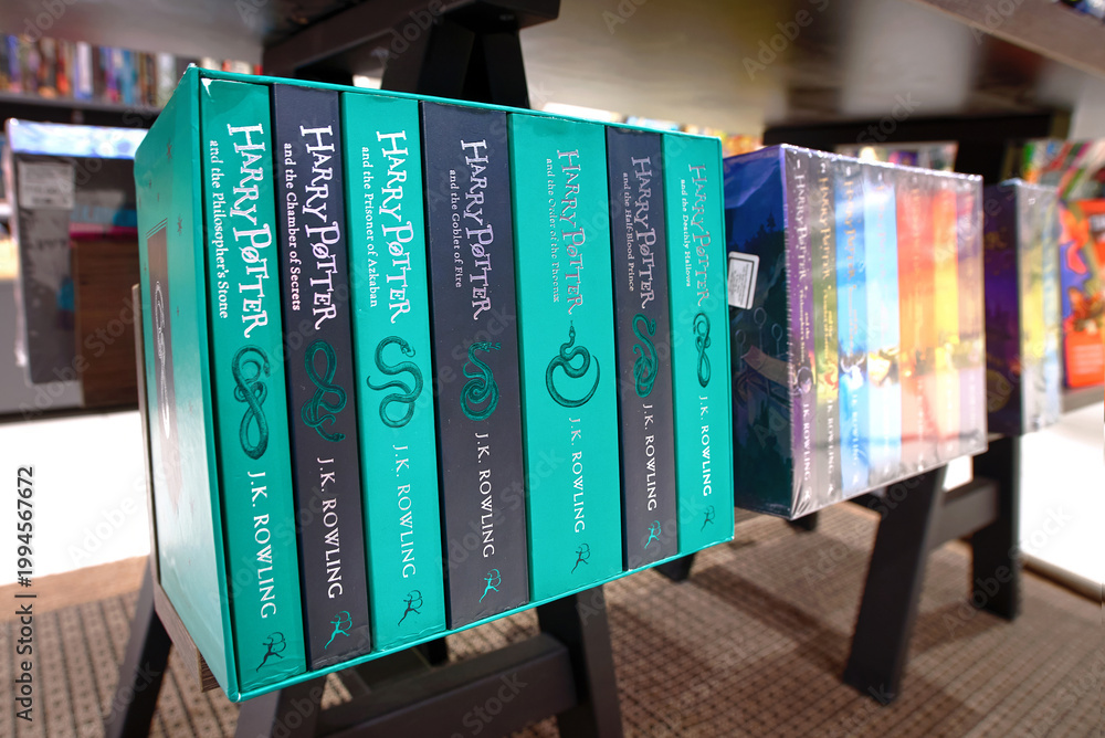 Fototapeta premium Minsk, Belarus. Apr 12, 2026. Collection of Harry Potter fantasy novels in special edition boxed sets shown on dark wooden retail display stand. Display of popular fantasy book series by J.K. Rowling