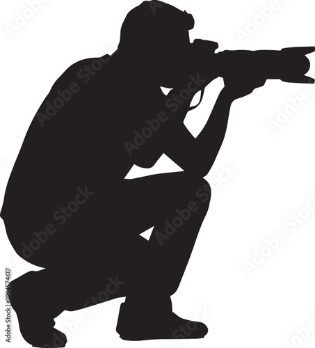 Silhouette of a photographer crouching and taking a photo with a professional DSLR camera.