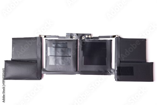 Modern Laptop Battery Repair Setup. Removable Battery Cell Pack On color Desk With Keyboard