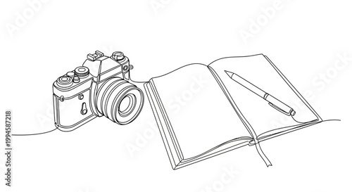 Billede på lærred Camera and notebook with pen.