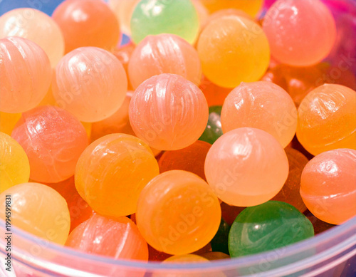  A high-resolution macro photograph of a collection of round, spherical hard candies. Ai