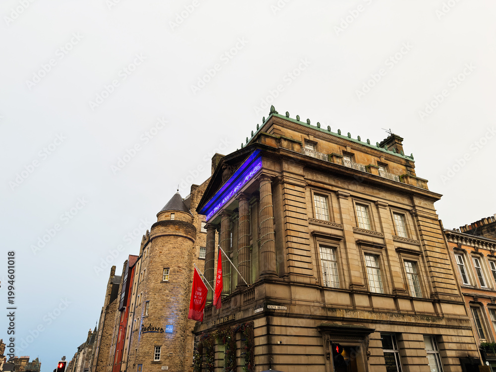 Obraz premium Historic stone The Inn On The Mile building with classical columns and turret on a city street in Edinburgh, Scotland, UK