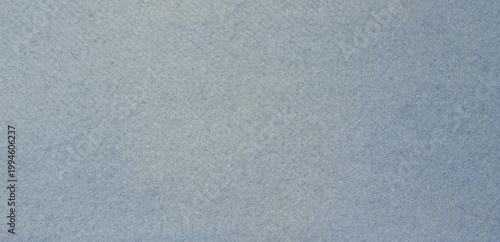Sky blue fabric texture background, seamless pattern of natural textile. Close-up of cashmere scarf with lint.