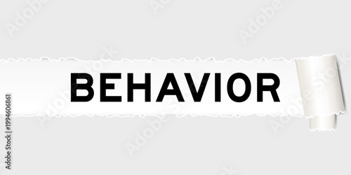 Ripped gray paper background that have word behavior under torn part