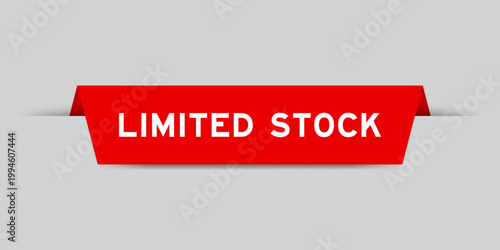 Red color inserted label with word limited stock on gray background