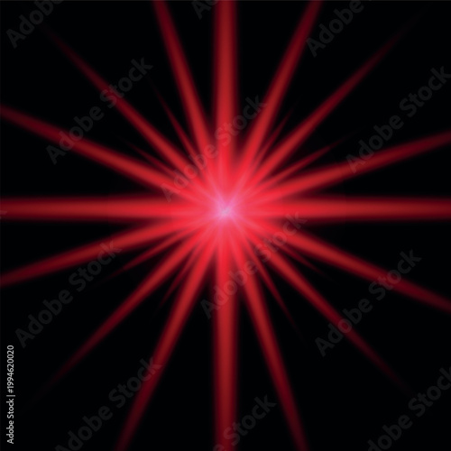Abstract red glowing light burst or lens flare effect on black background.