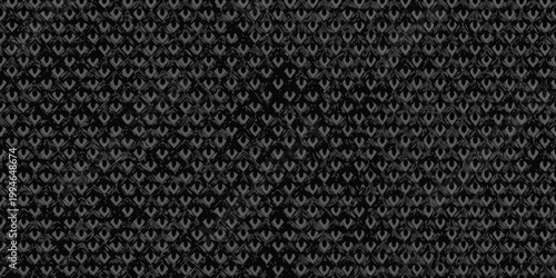 Intricate black and gray patterned textile with repeating floral motifs