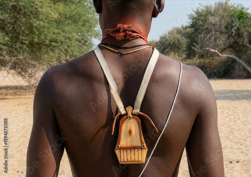 Himba tribe man with a wooden kalimba on his back, Cunene Province, Oncocua, Angola