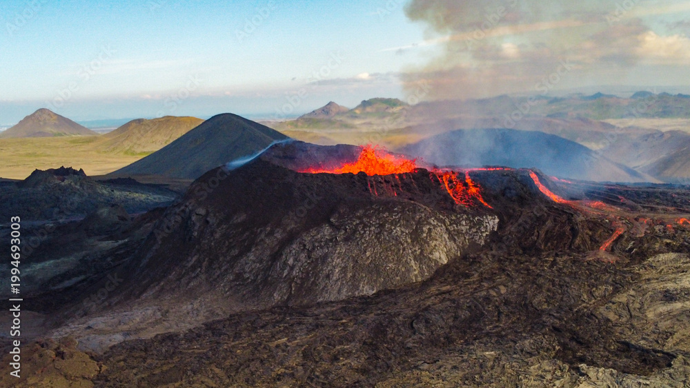 Fototapeta premium Aerial view of active Icelandic volcanic eruption with glowing lava and dramatic smoke plumes, YouTube 16x9 format.