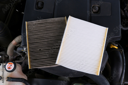 New vs. Dirty Engine Air Filter, A side-by-side comparison of a clean white car engine air filter and a dirty, clogged one