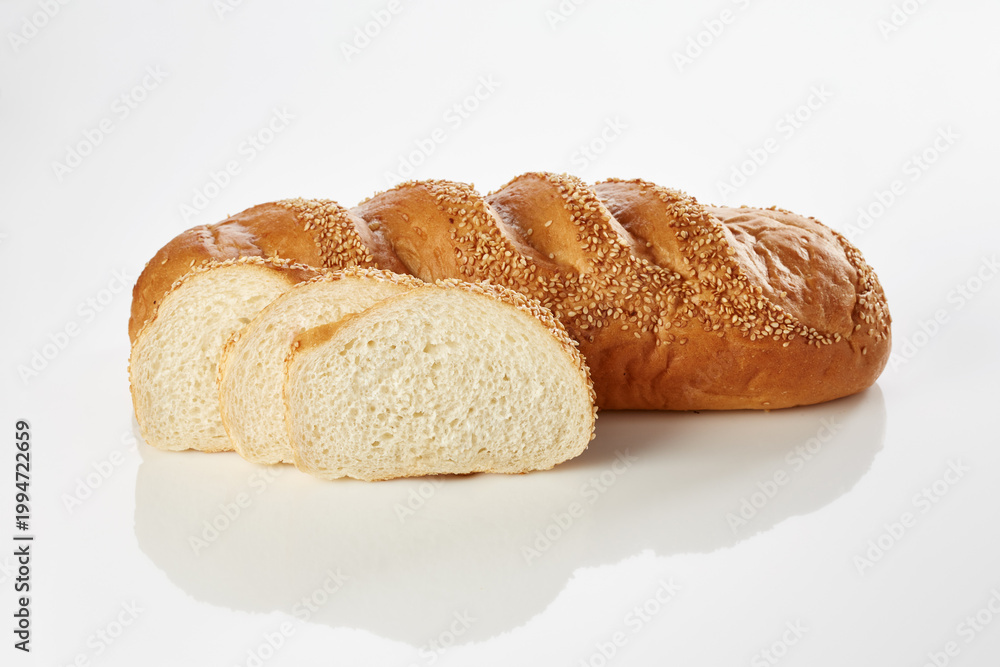 Fototapeta premium Sliced sesame bread loaf on white background