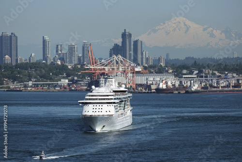 Modern cruiseship cruise ship ocean liner Brilliance sail away departure from port of Vancouver, British Columbia for Alaska summer cruising on sunny day with city skyline Mount Rainier background