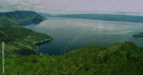 Aerial Drone View of Lake Toba with Green Hills and Calm Water